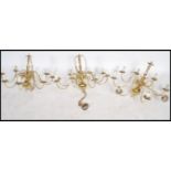 A set of 3 20th century antique style polished brass chandeliers, each with ball finials having