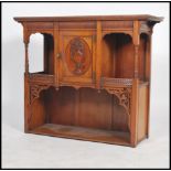 An Edwardian mahogany chiffonier base having central cupboards with columns to side and flared top