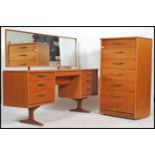 A 1970's teak wood dressing table chest Austin suite. The dressing table being raised on teak