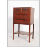 A late 19th / early 20th century mahogany two over three chest of drawers on stand raised on four
