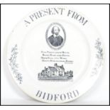 A 19th century decorative plate ' A Present from Bidford ' depicting William Shakespeare over