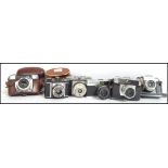 A collection of 6 vintage 20th century SLR camera's to include Zenit 3M, Haliner, Petri 7S II,