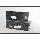 A pair of vintage 20th century tin storage trunks each having drop handles to side painted in an