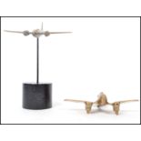 A 20th century trench art military interest brass model of a Wellington bomber raised on a large