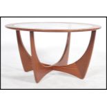 A retro teak wood atomic 'Astro' circular coffee table by G Plan, having a drop centre glass