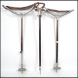 A group of three vintage 20th century shooting sticks with folding seats. Measures:  82cm high x