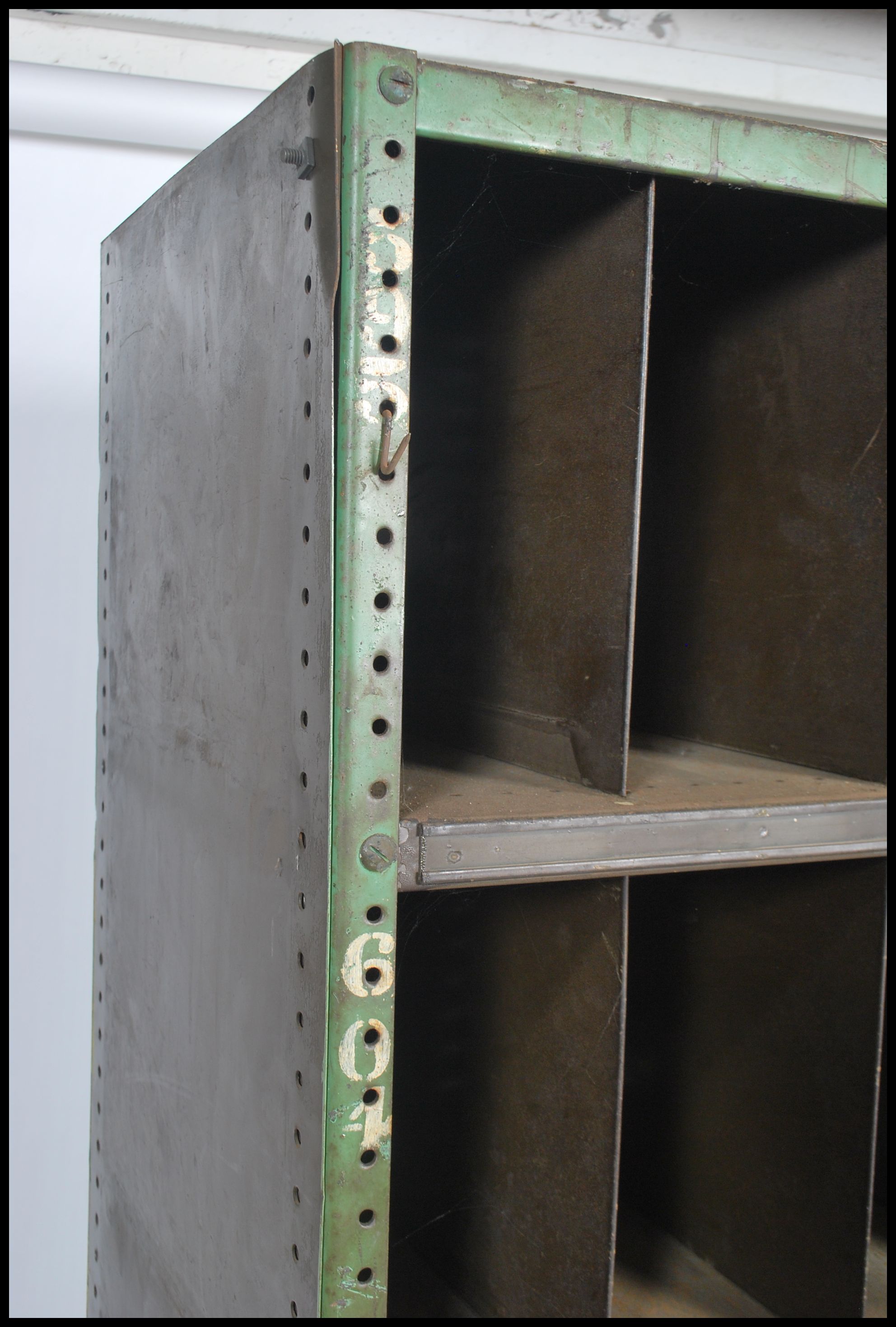 A slim original mid 20th century Industrial large green enamel metal sectional cubby cabinet. The - Image 4 of 4
