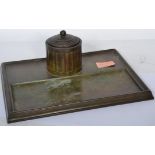 An early 20th century bronze inkwell desk tidy stand having a faceted inkwell with gadrooned lid