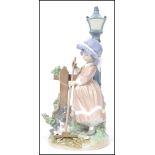 A Lladro ceramic figurine group entitled Fall Clean Up depicting a girl in bonnet  raking leaves