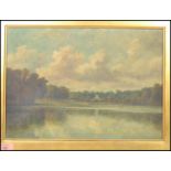 A 19th century framed oil on canvas English School painting of a lake scene surrounded by trees with