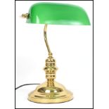 A 20th century contemporary green glass and brass bankers desk lamp having glass rectangular shade