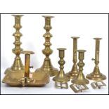 Three pair of vintage early 20th century brass candlesticks, a brass chamber stick and a group of