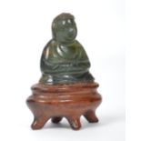 A vintage Oriental Chinese jade Buddha raised on a stone socle plinth. Measures 3.5 cms high.