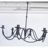 A fantastic 20th century six point wrought iron ebonised chandelier, having swag and scroll work