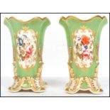 A pair of 19th century English factory vases having a green ground with white cartouche panels