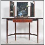 A good 1950's post modernist teak wood duchess dressing table being raised on tapering legs united