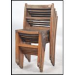 A set of vintage mid century wooden stacking chairs having slatted seats with squared legs and panel