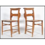 A pair of early 20th century  elm chapel chairs fitted with hymnal tray, curved top rail, turned