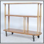 An Ercol beech and elm wood 20th century low room divider having chamfered edge lozenge shaped tiers