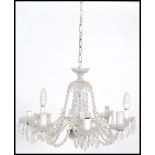 A vintage 20th century glass eight sconce chandelier having eight branches adorned with multiple