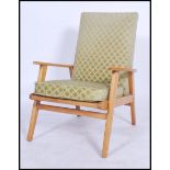 A retro mid century Danish inspired armchair having show wood angular teak frame with with swept