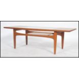 A 1970's teak G Plan teak wood atomic coffee table. The shaped legs under circular top with inset