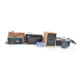 A collection of vintage 20th century cameras to include a boxed brownie, two vintage fold out