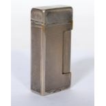 A vintage 20th century Dunhill lighter having an engine turned decoration with stamps to bottom,