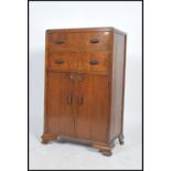 A vintage early 20th century Art Deco oak tall boy rasied on shaped feet with two drawers over