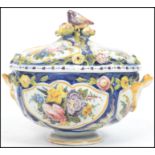 A stunning lidded twin handled Faience tureen / dish, each panel decorated with hand painted fauna