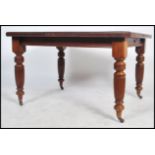 A Victorian extending pull out dining table together with an additional leaf. The table being raised