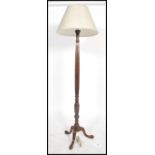 A good quality early 20th century standard lamp raised on cabriole squat legs and pad feet having