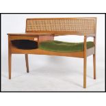 A retro 1970's teak wood telephone table / seat by Mr Chippy, rattan weave style back, button back