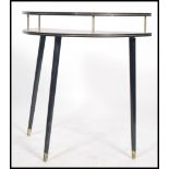 A 1970's retro demi loom side / hall table raised on tapering ebonised legs with half moon top and