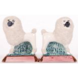 A pair of early 20th century Victorian Staffordshire porcelain miniature poodles, standing on