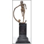 A 20th century Art Deco style bronze effect erotic figurine with cape and ball mounted on a faux