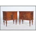A pair of early 20th century Italian walnut bedside cabinets, each being raised on turned and