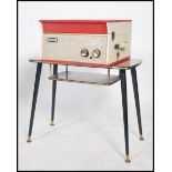 A vintage 20th century retro mid century Dansette record player having a two tone case with