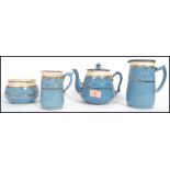 A 19th century Victorian four piece stone ware ceramic tea service having a blue ground with gilt