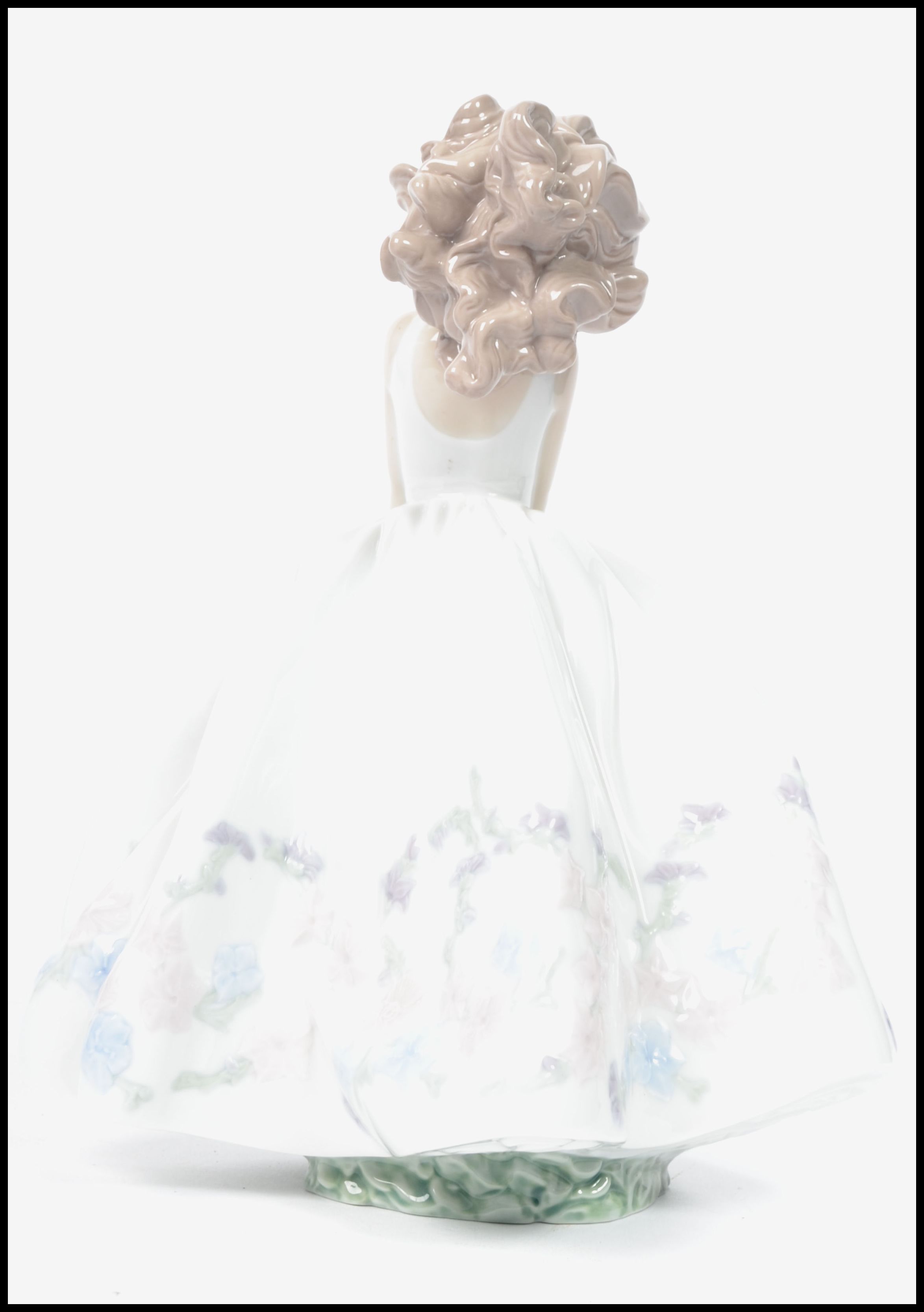 A Lladro ceramic figurine of a girl in dress holding a flower basket with floral bush to base. - Image 3 of 5