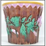 A 19th century Majolica ceramic jardiniere having a lilac ground moulded in relief with fences and