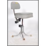 A vintage 20th century retro industrial office swivel chair in the manner of Tansad raised on a