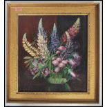 A framed oil on canvas painting still life study of a vase of flowers signed to the corner Ethel