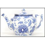 An early 20th century blue and white ceramic teapot of traditional form with shaped handle and spout