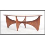 A retro teak wood atomic 'Astro' oval coffee table by G Plan, having a drop centre glass panel,