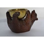 An early 20th carved oak blackforest / black forest bear carved in a reclined position with glass