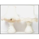 A pair of Irish 20th century Belleek ceramic table lamps decorated in the shamrock pattern, complete