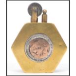 A 20th century trench art military lighter of hexagonal form having an inset British and French coin