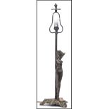 A 20th century art deco style bronze effect table lamp raised on a rococo influence tripod base