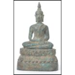 A 19th century Oriental bronze figure of a Buddha moulded in the lotus position raised on a pedestal